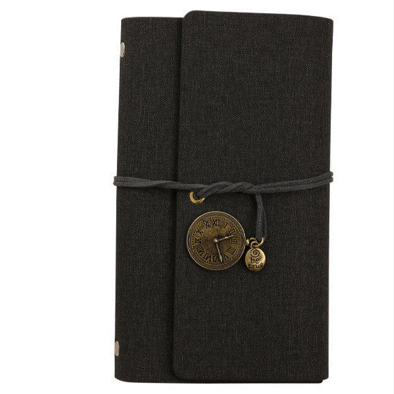 Black PU vegan leather notebook with a decorative charm on a white background