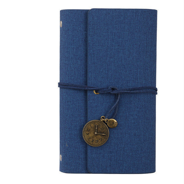 Blue PU vegan leather notebook with a decorative charm on a white background